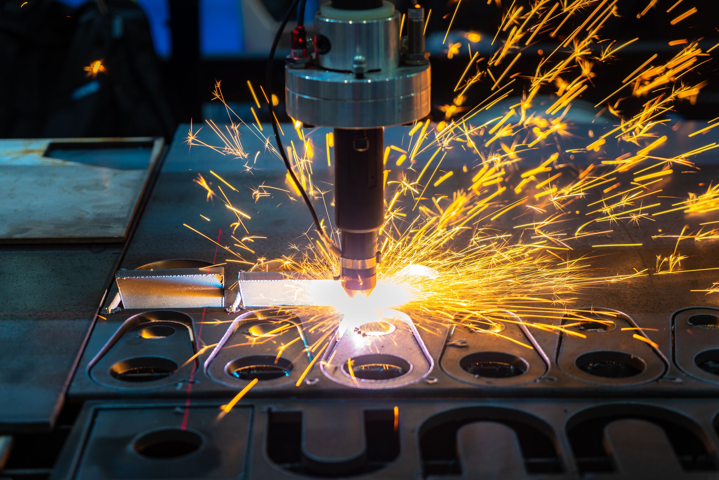CNC machine cutting metal and sparking.